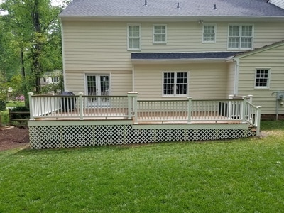 back of house with new Trex deck and white rails