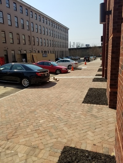 Brick paver sidewalk laid in modified herringbone pattern